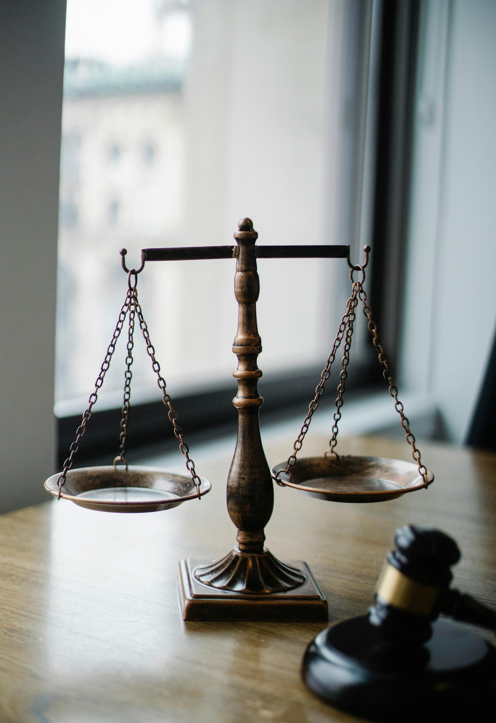 Scales of justice on a courtroom desk